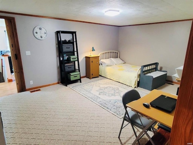 carpeted bedroom with ornamental molding