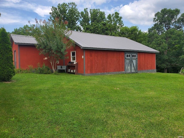 view of outdoor structure featuring a lawn