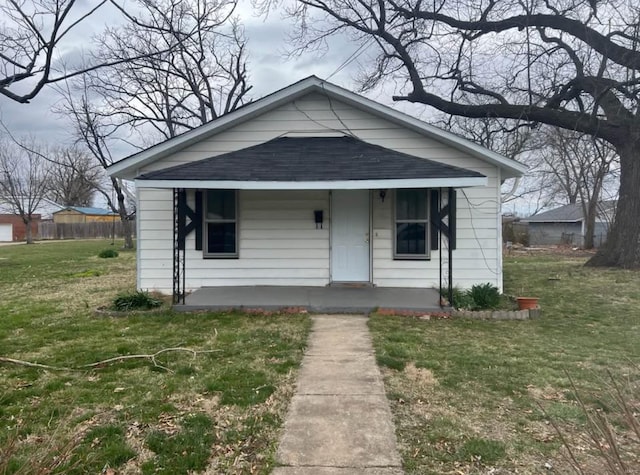 bungalow-style home with a front lawn