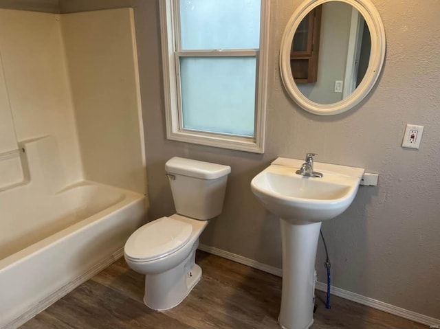 bathroom with wood-type flooring, toilet, and shower / bath combination