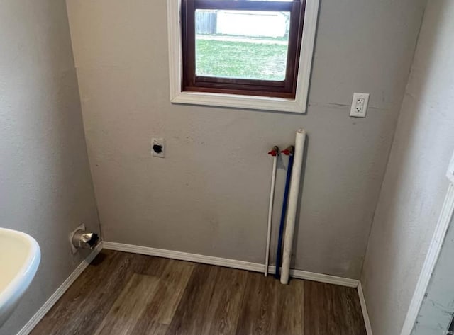 washroom featuring dark hardwood / wood-style floors and hookup for an electric dryer