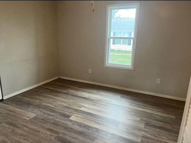 unfurnished room with dark hardwood / wood-style flooring