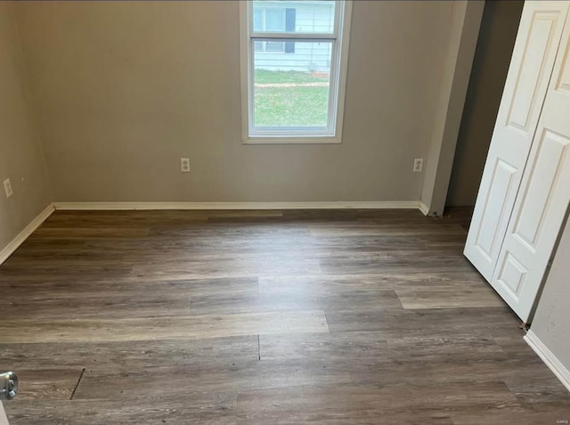 unfurnished bedroom with dark hardwood / wood-style floors