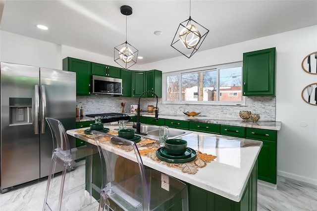 kitchen with appliances with stainless steel finishes, decorative light fixtures, tasteful backsplash, sink, and a center island