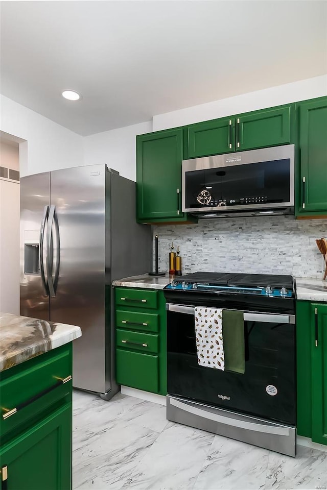 kitchen featuring tasteful backsplash, appliances with stainless steel finishes, and green cabinets