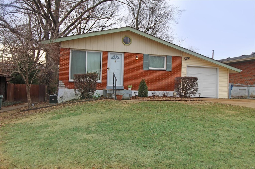 single story home with a garage and a front yard