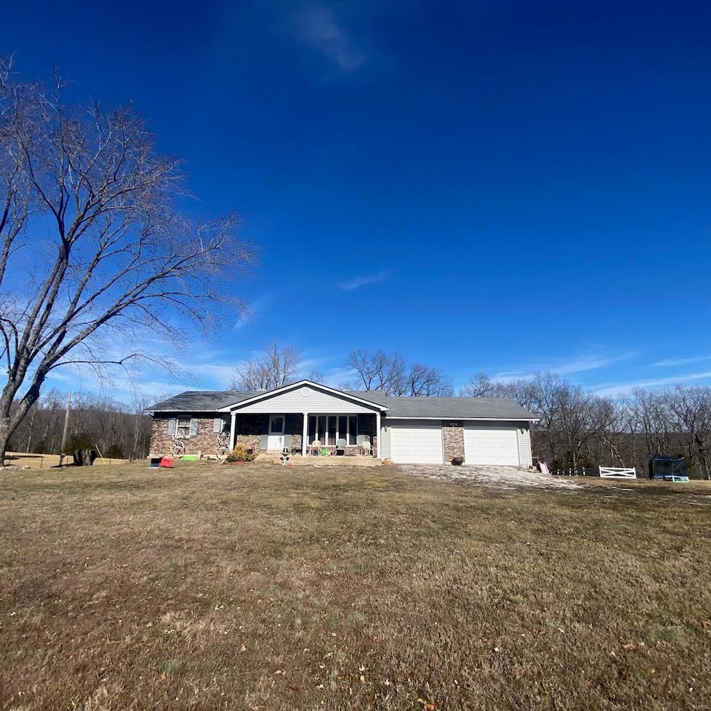 single story home with a garage and a front yard