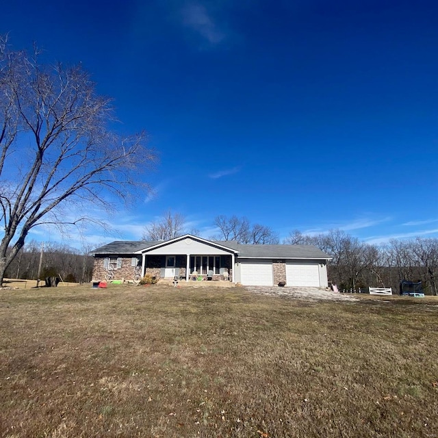 single story home with a garage and a front yard