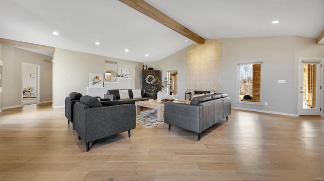 living room with lofted ceiling with beams and light wood-type flooring