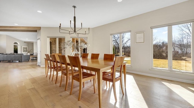 dining room with a notable chandelier and light wood-type flooring