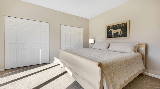 carpeted bedroom featuring multiple closets