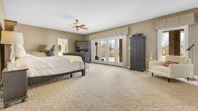 bedroom featuring light carpet, multiple windows, french doors, and ceiling fan