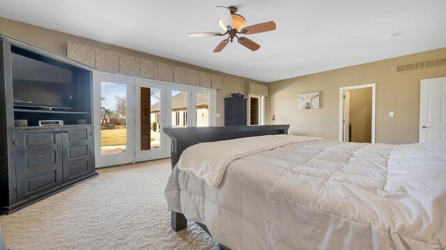 bedroom with access to outside, light colored carpet, and ceiling fan