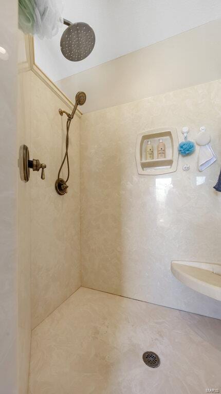 bathroom with a tile shower