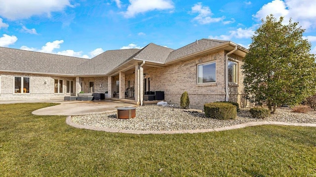 back of house featuring a lawn, central AC unit, and a patio area