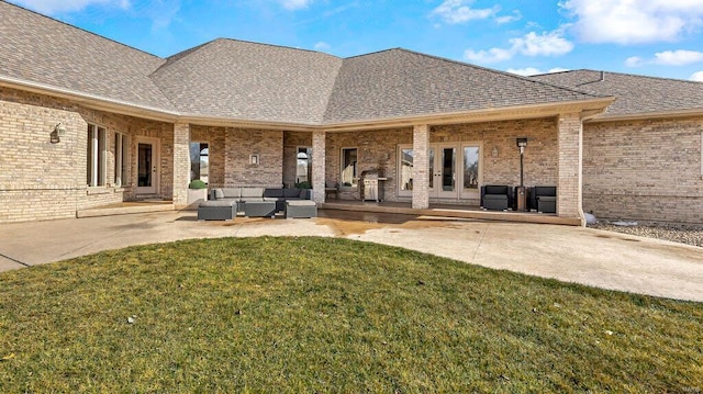 rear view of house featuring french doors, a yard, outdoor lounge area, and a patio