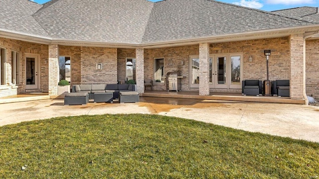 back of property featuring french doors, outdoor lounge area, a patio, and a lawn