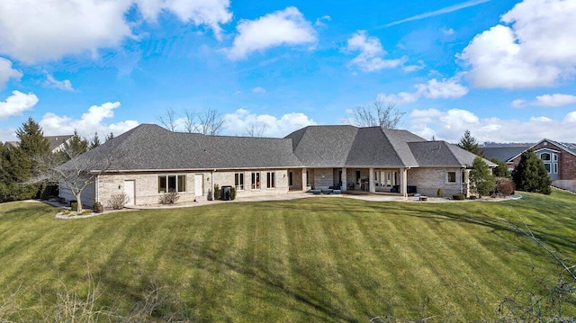 back of property featuring a yard and a patio area