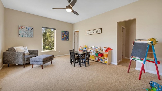 rec room with ceiling fan and light carpet