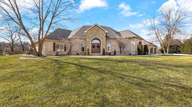 french country style house with a front lawn