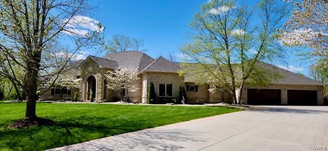 view of front of property with a garage and a front lawn