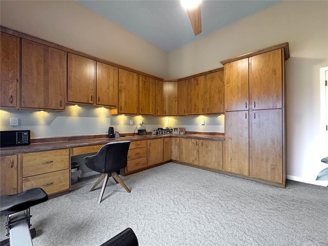 kitchen with built in desk and ceiling fan