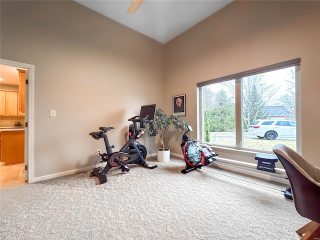 workout area featuring lofted ceiling, carpet flooring, and ceiling fan