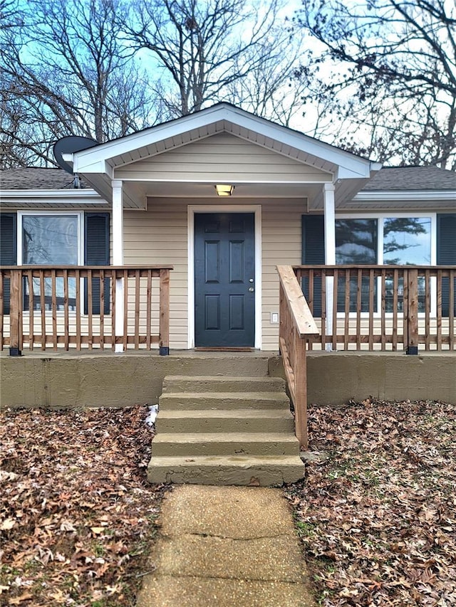 view of exterior entry featuring a porch