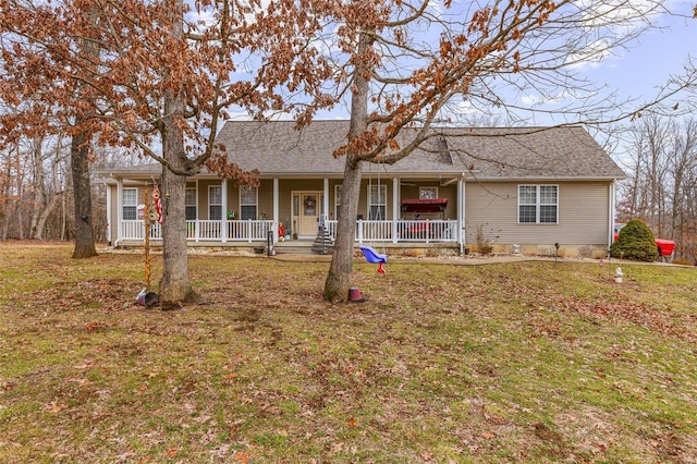 ranch-style home featuring covered porch and a front lawn