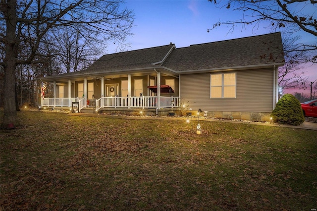 view of front facade with a porch and a yard