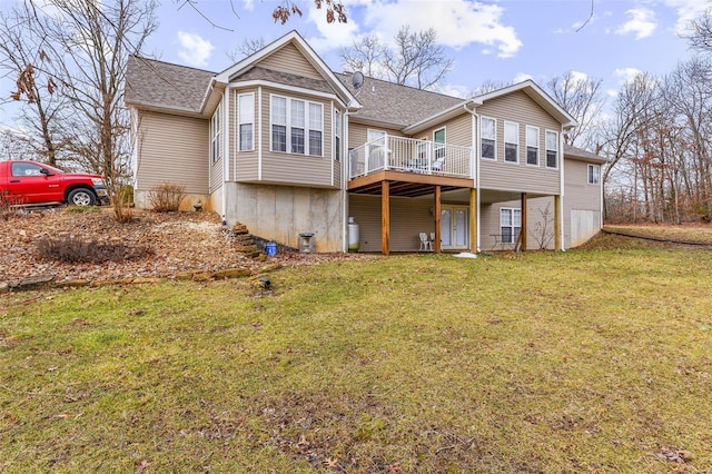 back of house featuring a lawn and a deck