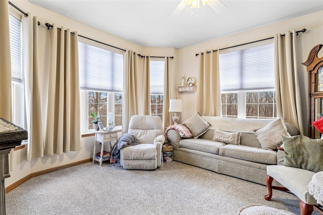 carpeted living room with ceiling fan