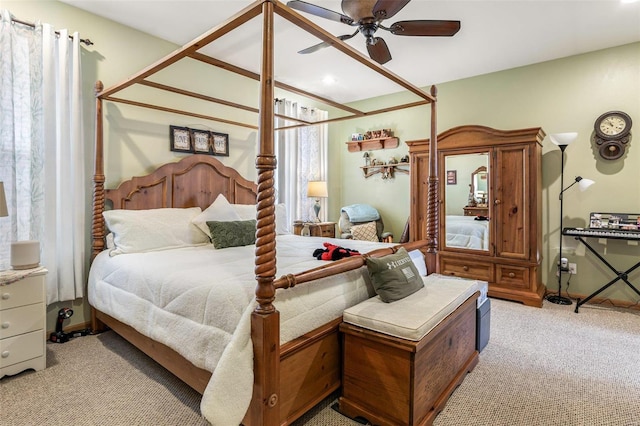 bedroom featuring ceiling fan and light carpet