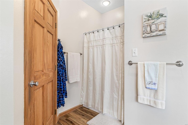 bathroom featuring a shower with curtain and wood-type flooring