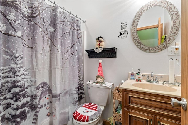 bathroom with vanity, curtained shower, and toilet