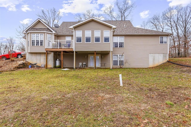 back of property featuring a lawn and a deck