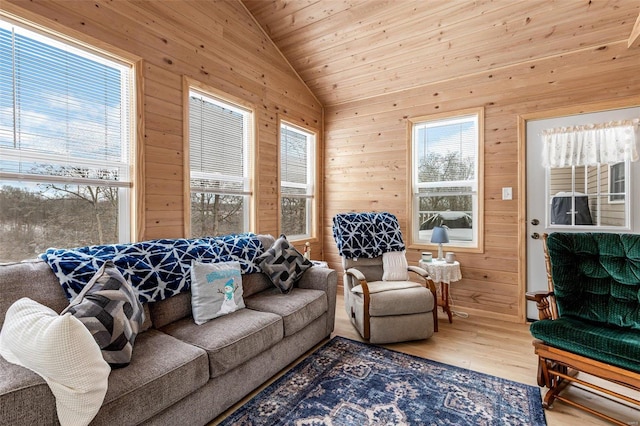 living room with lofted ceiling, hardwood / wood-style floors, wooden ceiling, and wood walls