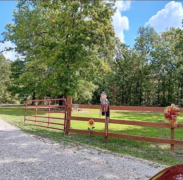 view of gate featuring a yard