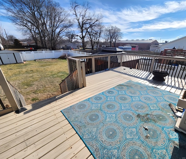 wooden terrace featuring a lawn