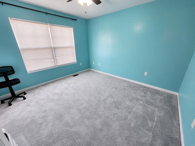 spare room with carpet and ceiling fan