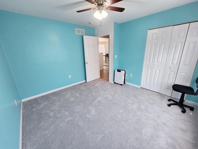 unfurnished bedroom featuring ceiling fan, carpet flooring, and a closet