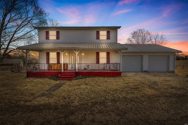 country-style home featuring a garage, a lawn, and covered porch