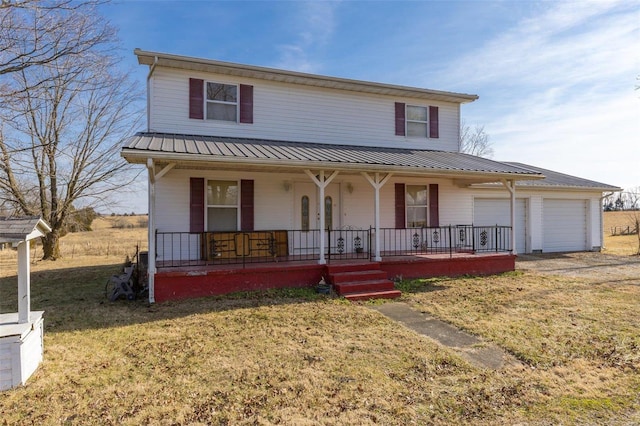 view of front of house featuring a garage, covered porch, and a front lawn