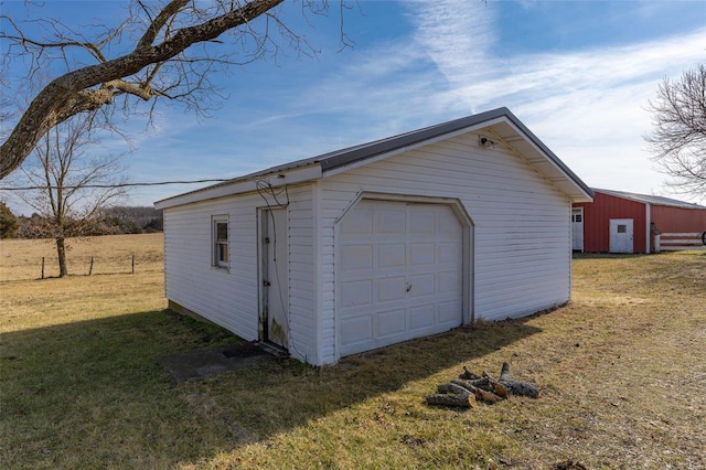 garage featuring a lawn