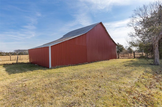 view of outdoor structure featuring a yard and a rural view