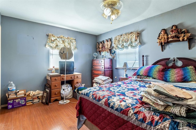 bedroom with ceiling fan and wood-type flooring