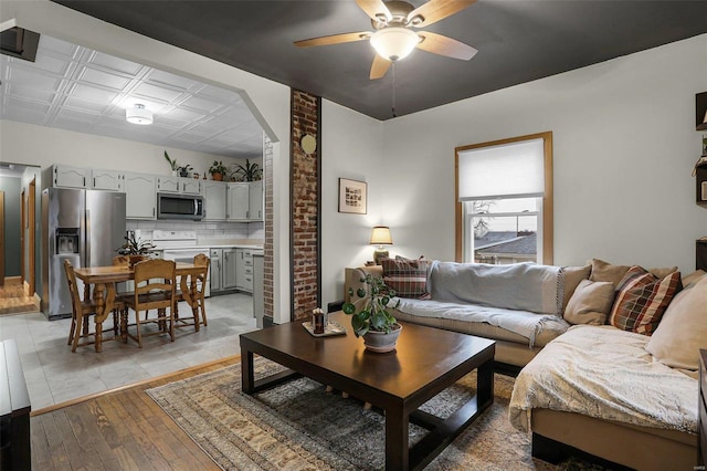 living room with ceiling fan and light hardwood / wood-style floors