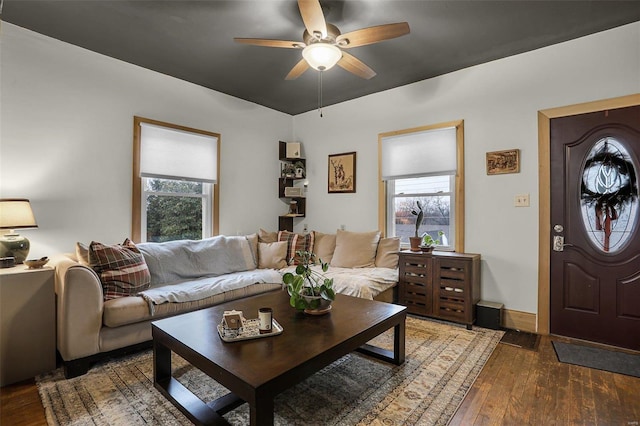 living room with ceiling fan, dark wood-type flooring, and a healthy amount of sunlight