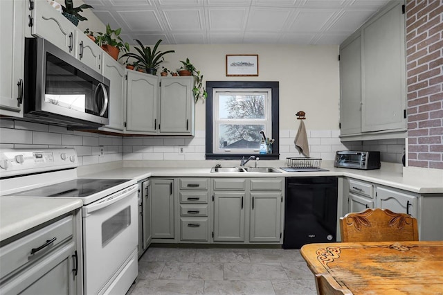 kitchen featuring sink, white electric range, gray cabinetry, black dishwasher, and tasteful backsplash