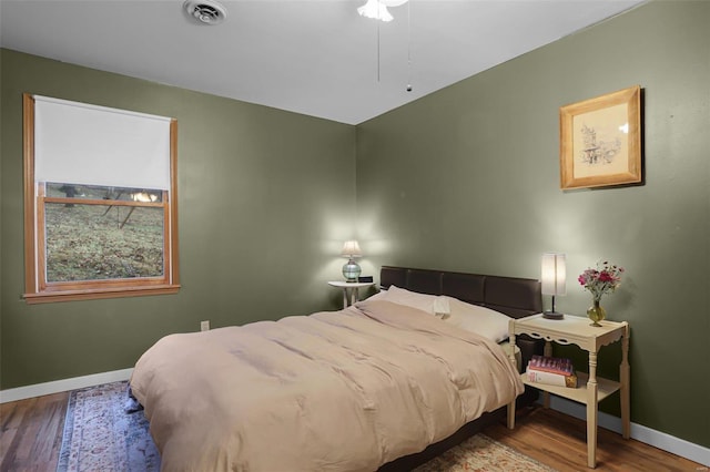 bedroom with hardwood / wood-style floors